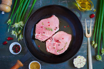 Organic pork lion chops on cast iron frying pan, Top view