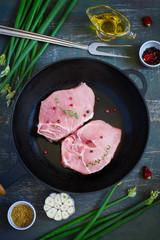 Organic pork lion chops on cast iron frying pan, Top view