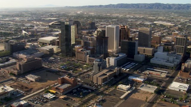 Flight past downtown Phoenix with wide view to mountains. Shot in 2007.