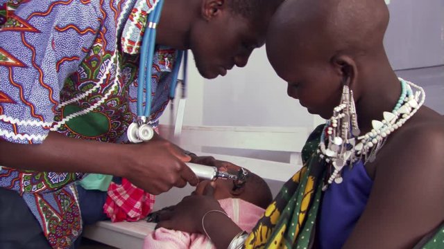 Child getting an ear exam in a Tanzanian clinic
