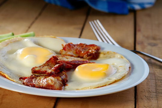Fried eggs with bacon and fork