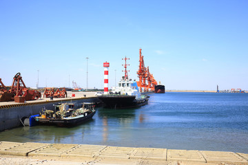 Fototapeta na wymiar In freight terminal, gantry crane and cargo ships are in loading