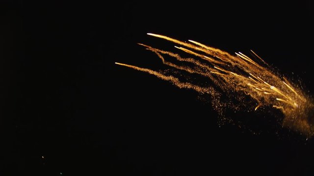 Multiple rockets fly into frame from right and sparks fly toward camera; smoky explosions blossom