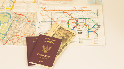 Passport and Japanese banknote on blur subway map