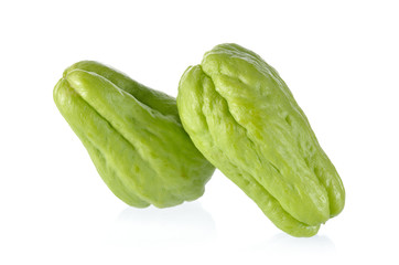 uncooked whole fresh chayote on white background