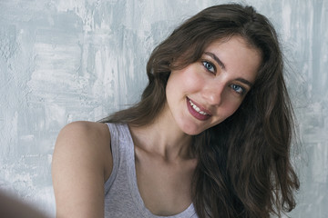 Smiling girl with long hair taking selfie