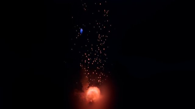 Flame explosion with flaring fireball and blue spark