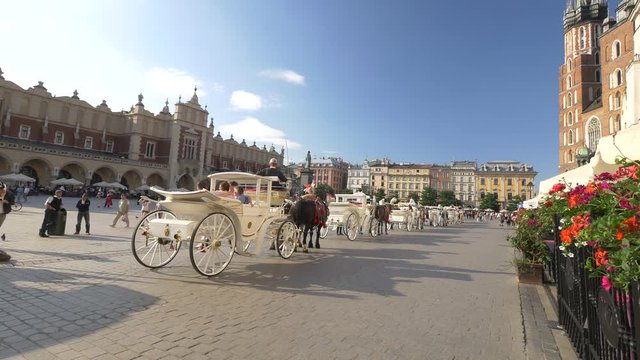 Beautiful, white carriage on the Cracow's market square.