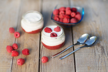 yogurt with fresh raspberry on wooden background. healthy morning breakfast.

