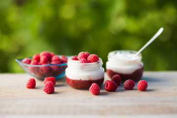 yogurt with fresh raspberry on wooden background. healthy morning breakfast.


