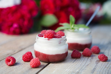 yogurt with fresh raspberry on wooden background. healthy morning breakfast.


