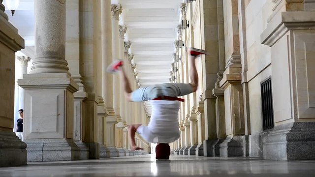 Young breakdancer dancing on the street in Karlovy vary, Czech Republic
