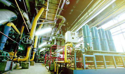 Equipment, cables and piping as found inside of a modern industr