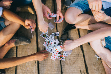 a group of guys playing cards, view from top