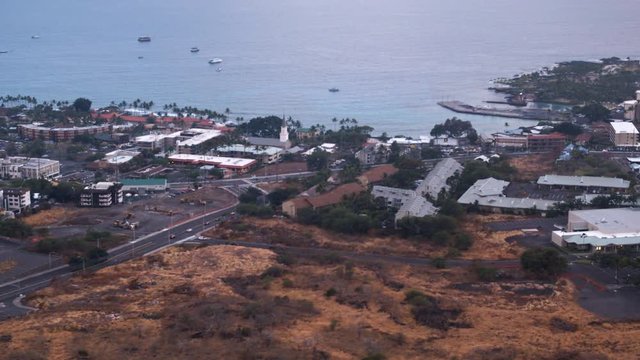 Flying over Kona Town, Hawaii, with wide view of bay. Shot in 2010.