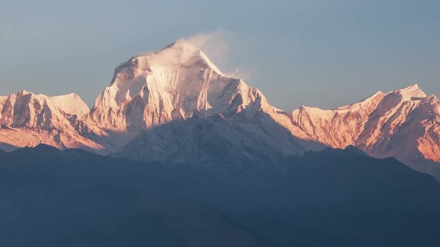 Snow avalanche falling from Dhaulagiri peak (8167 m) at sunrise. Time Lapse.