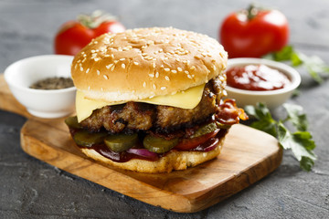 Cheeseburger with pickled cucumbers and bbq sauce