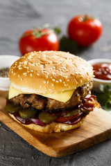 Cheeseburger with pickled cucumbers and bbq sauce