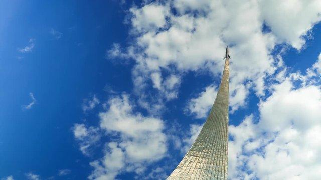 Steel space rocket monument in Moscow against cloudy sky 4K time lapse