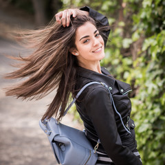 Young woman moving her hair in urban background