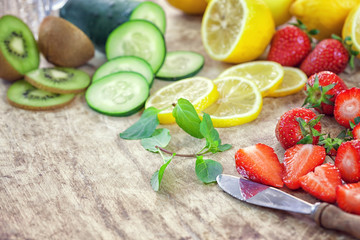 Fresh fruit - ingredients for detox infused water on wooden background