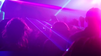 Nightclub party clubbers with hands in air