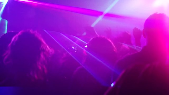 Nightclub party clubbers with hands in air