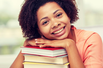 happy african student girl with books at home