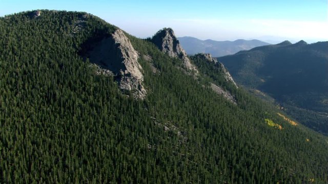 Flight over forested summit in Colorado Rockies