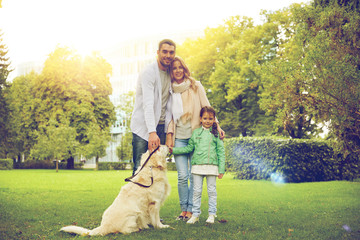 happy family with labrador retriever dog in park