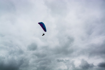 Hang glider floating among the storm clouds at Dunstable Downs in UK summer