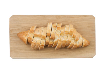 White small bread being cut on wooden board