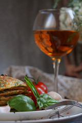 Vegetarian zucchini fritters served with fresh herbs, tomatoes a
