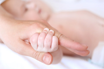 Fototapeta na wymiar Child hand holding parent hand, closeup