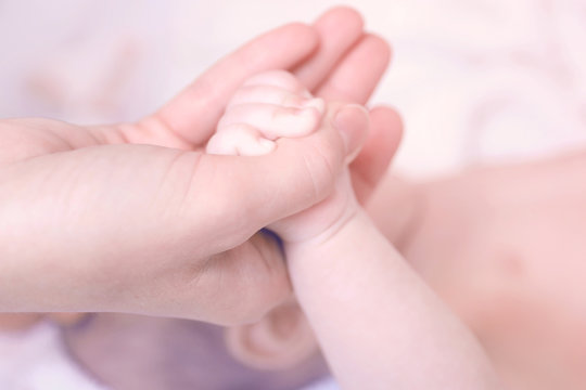 Child hand holding parent hand, closeup