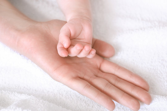 Child and female hand, closeup