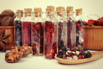 Assorted dry spices in glass bottles, close up