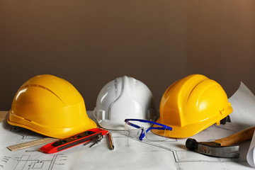 Construction plans and builder equipment on table