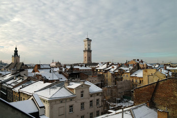 Panoramic view on winter Lvov, city tower and roofs covered with snow