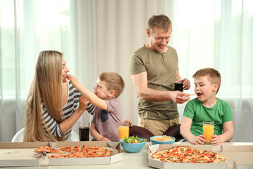 Happy lovely family eating pizza