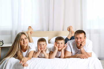 Happy lovely family on bed