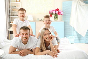 Happy lovely family on bed