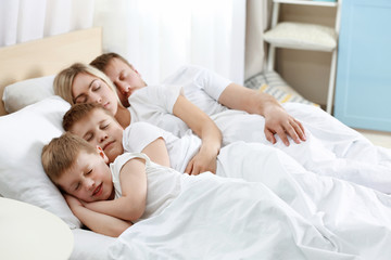 Fototapeta na wymiar Lovely sleeping family in bed