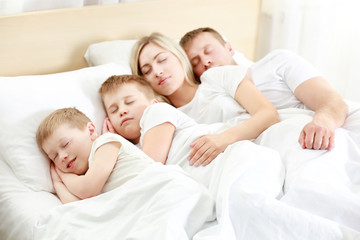 Fototapeta premium Lovely sleeping family in bed