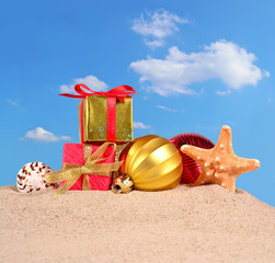 Christmas decorations seashells and starfish on a beach sand