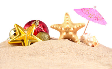 Christmas decorations seashells and starfish on a beach sand on