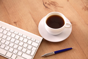Office table with blank notepad and laptop