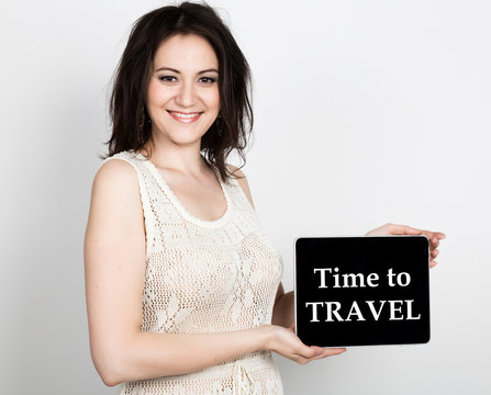technology, internet and networking - close-up successful woman holding a tablet pc with time to travel sign. internet technology in tourism