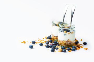 Cereal musli with yogurt and blueberries on white background