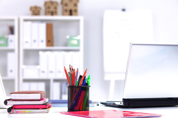 Designer working desk with a computer and paperwork